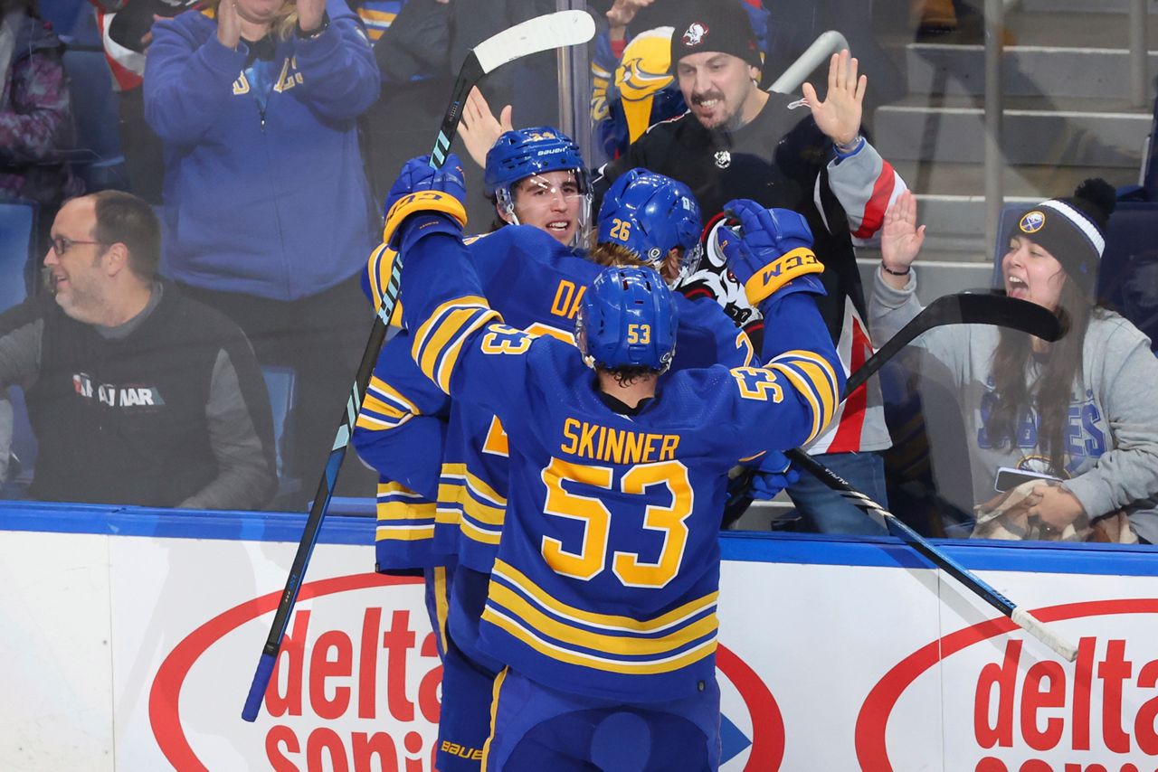 Buffalo Sabres center Dylan Cozens, left, celebrates his game winning goal with defenseman Rasmus Dahlin (26) and left wing Jeff Skinner (53) during the overtime period of an NHL hockey game against the Tampa Bay Lightning Tuesday, Oct. 17, 2023, in Buffalo, N.Y. (AP Photo/Jeffrey T. Barnes)