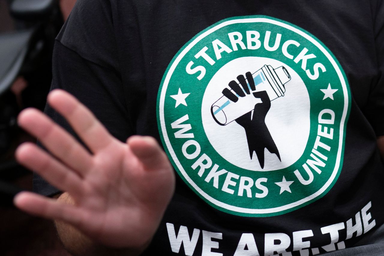 The Starbucks Workers United logo appears on the shirt of a former Starbucks employee on March 29, 2023.