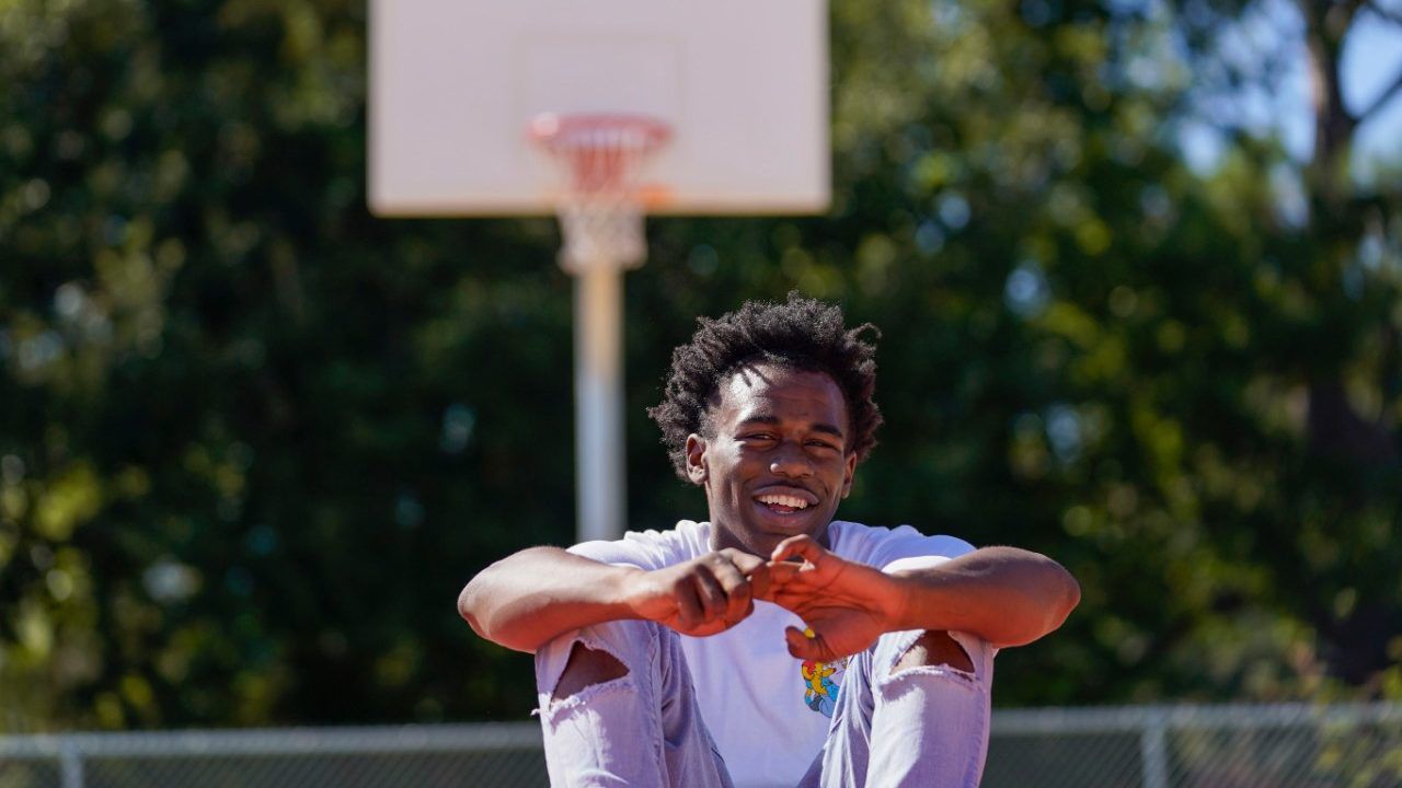 Bryant West poses for a portrait on a basketball court built by NBA star Devin Booker, who went to high school here, in Moss Point, Miss., Friday, Oct. 20, 2023. Girls consistently are outperforming boys, graduating at higher rates at public high schools around the country. Students, educators and researchers say there are several reasons why boys are falling short.(AP Photo/Gerald Herbert)