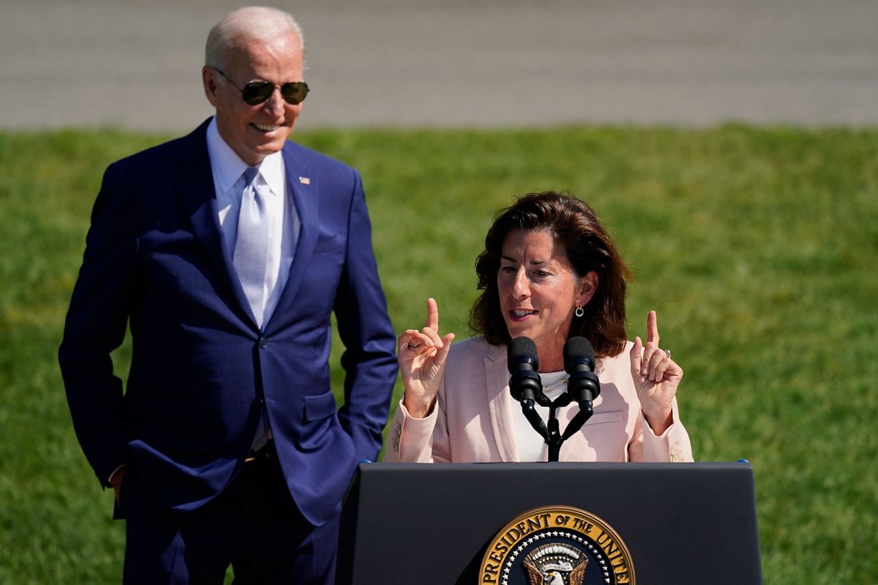 FILE - President Joe Biden looks on as Commerce Secretary Gina Raimondo speaks on the South Lawn of the White House, Aug. 9, 2022, in Washington. The Biden administration is designating 31 “tech hubs” in 32 states and Puerto Rico to help spur innovation and create jobs in the specific industries that are concentrated in these areas. “I have to say, in my entire career in public service, I have never seen as much interest in any initiative than this one," Raimondo told reporters during a Sunday, Oct. 22, 2023, conference call to preview the announcement. (AP Photo/Carolyn Kaster, File)