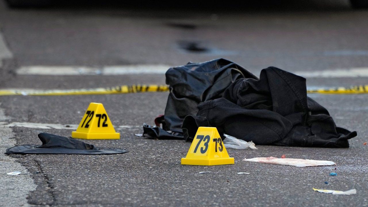 A witch hat, left, and an unidentified object are shown in the street near evidence markers in the Ybor City section of Tampa, Fla., after a shooting, Oct. 29, 2023. Shootings across the U.S. over the party weekend before Halloween have left at least 11 people dead and more than 70 injured. Authorities say the deaths between Friday and Sunday included two in Tampa, Florida, three in Texarkana, Texas, and two each in Kansas, San Antonio, Texas and Mansfield, Ohio. Many involved altercations arising from Halloween celebrations, including the mass shooting in Tampa’s Ybor City section early Sunday as bars were closing and scores of people in costumes spilled out on the streets. (AP Photo/Chris O'Meara, file)