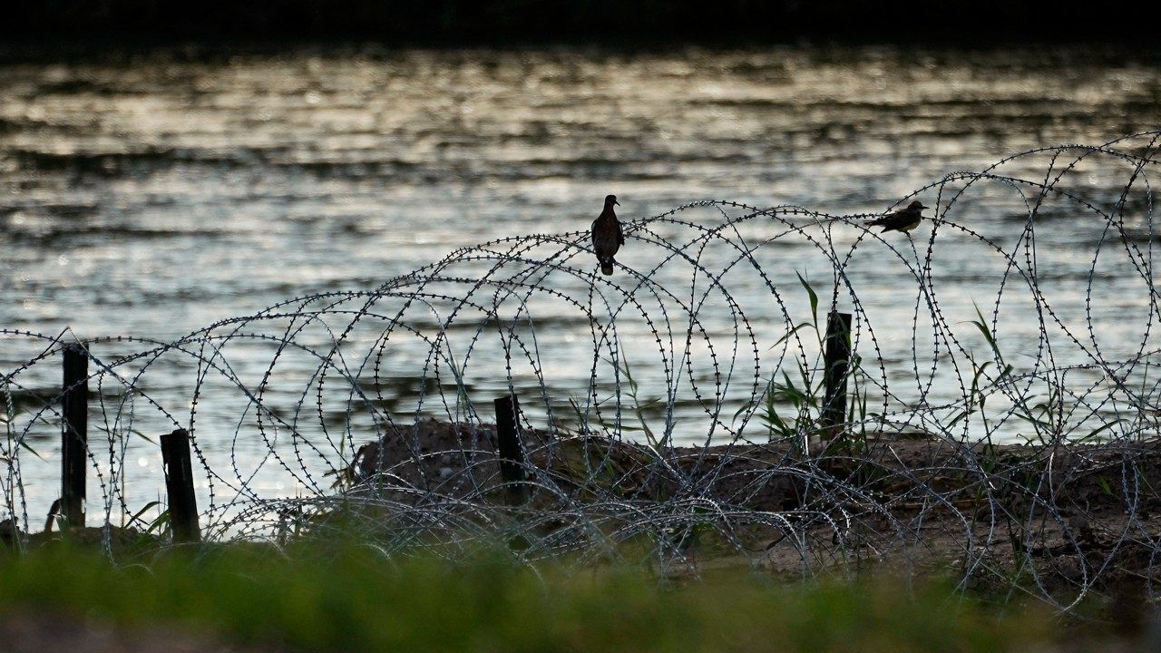 Birds rest on concertina wire, or razor wire, along the Rio Grande in Eagle Pass, Texas, July 6, 2023. A federal judge on Monday, Oct. 30, ordered Border Patrol agents not to interfere with razor wire that Texas has installed at a busy crossing for migrants on the U.S.-Mexico border, keeping in place, for now, one of Republican Gov. Greg Abbott's newest aggressive measures over immigration. (AP Photo/Eric Gay, File)