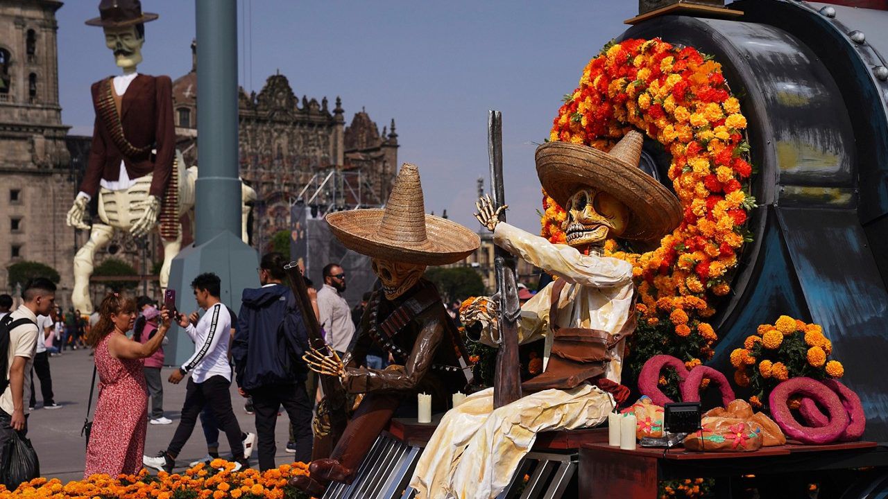 Visitors take photos of Day of the Dead themes presentations at Mexico City´s main square the Zocalo, Tuesday, Oct. 31, 2023. (AP Photo/Marco Ugarte)