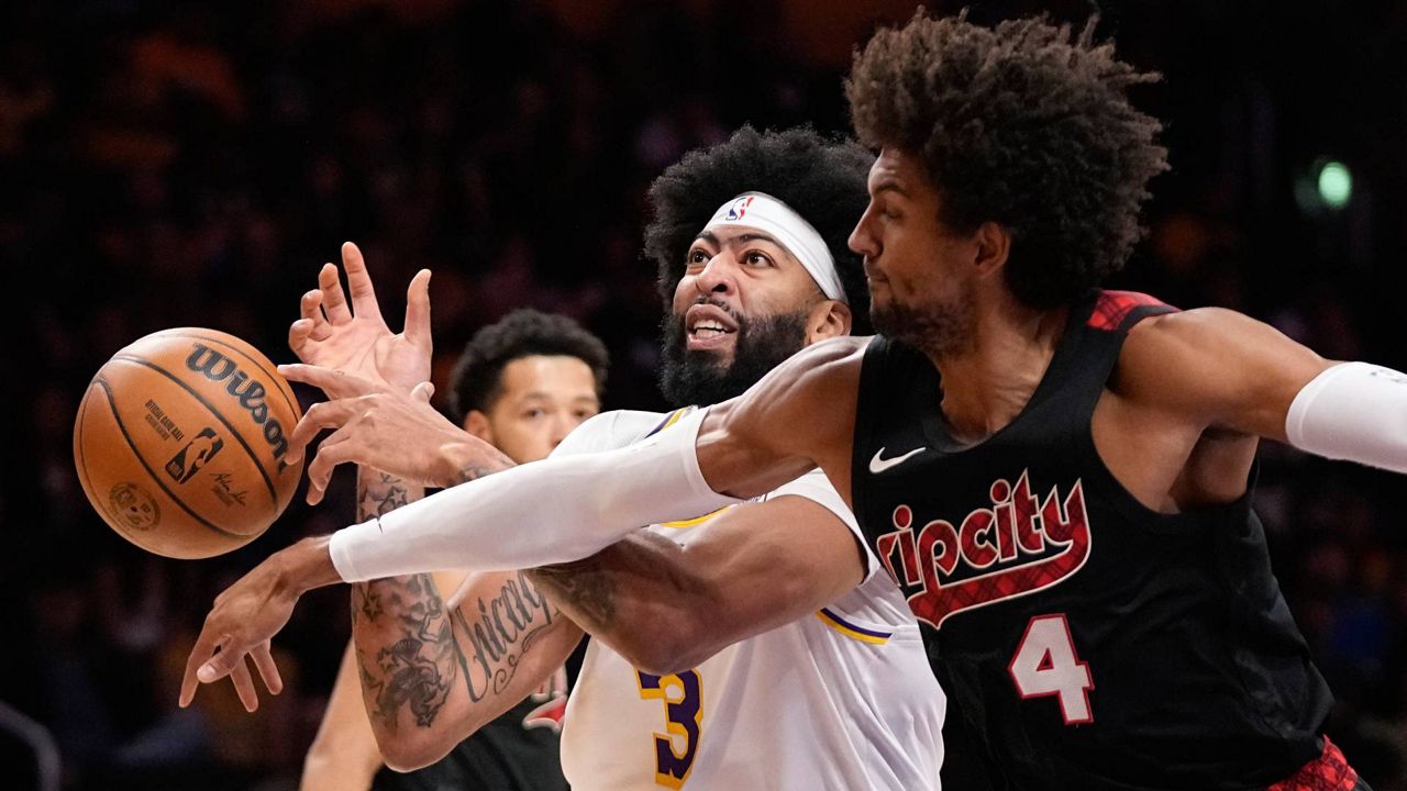 Portland Trail Blazers guard Matisse Thybulle, right, knocks the ball from the hands of Los Angeles Lakers forward Anthony Davis during the first half of an NBA basketball game Sunday in LA. (AP Photo/Mark J. Terrill)