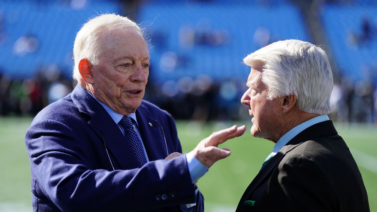 Dallas Cowboys owner Jerry Jones talks with former coach Jimmy Johnson before an NFL football game between the Carolina Panthers and the Dallas Cowboys on Sunday, Nov. 19, 2023, in Charlotte, N.C. (AP Photo/Rusty Jones)