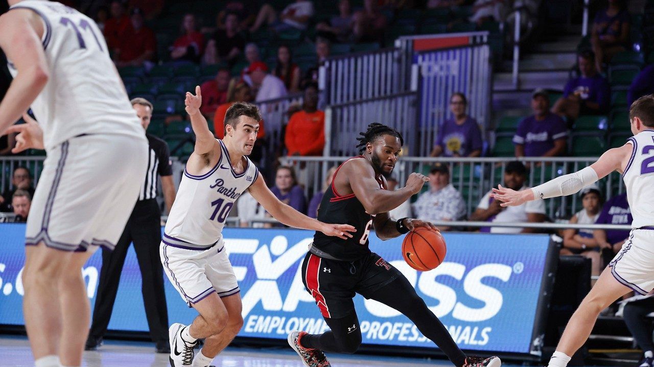 In a photo provided by Bahamas Visual Services, Texas Tech's Joe Toussaint drives to the basket between Northern Iowa's RJ Taylor (10) and Northern Iowa's Kyle Pock (22) during an an NCAA college basketball game in the Battle 4 Atlantis at Paradise Island, Bahamas, Thursday, Nov. 23, 2023. (Tim Aylen/Bahamas Visual Services via AP)