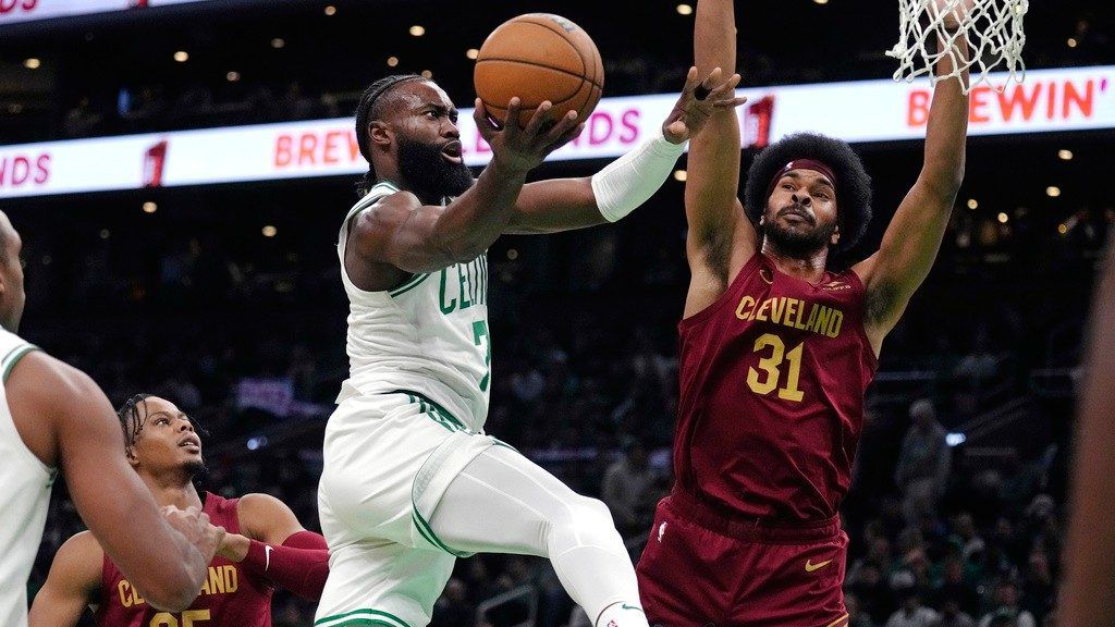 Boston Celtics guard Jaylen Brown, left, drives to the basket against Cleveland Cavaliers center Jarrett Allen (31) during the first half of an NBA basketball game, Tuesday, Dec. 12, 2023, in Boston.