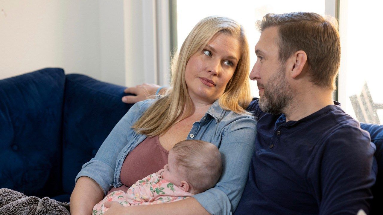 Kaitlyn Kash and husband Cory Kash sit at home with their 4-month-old daughter, Sunday, Dec. 17, 2023, in Austin, Texas. Kaitlyn Kash has joined as a plaintiff on the Zurawski v. State of Texas case, a lawsuit that looks to clarify the scope of the state's abortion ban. (AP Photo/Stephen Spillman)