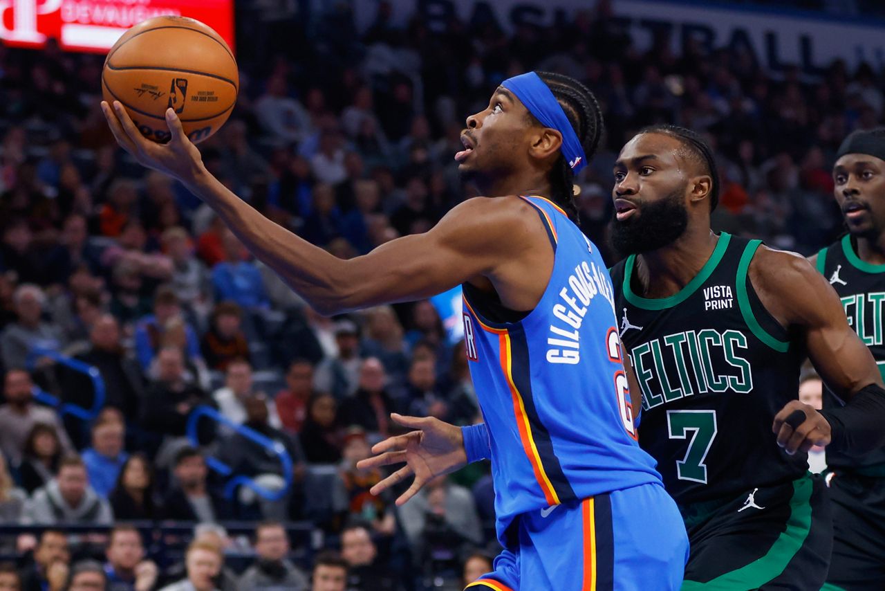 Oklahoma City Thunder guard Shai Gilgeous-Alexander, left, prepares to shoot in front on Boston Celtics guard Jaylen Brown (7) during the first half of an NBA basketball game, Tuesday, Jan. 2, in Oklahoma City. (AP Photo/Nate Billings)