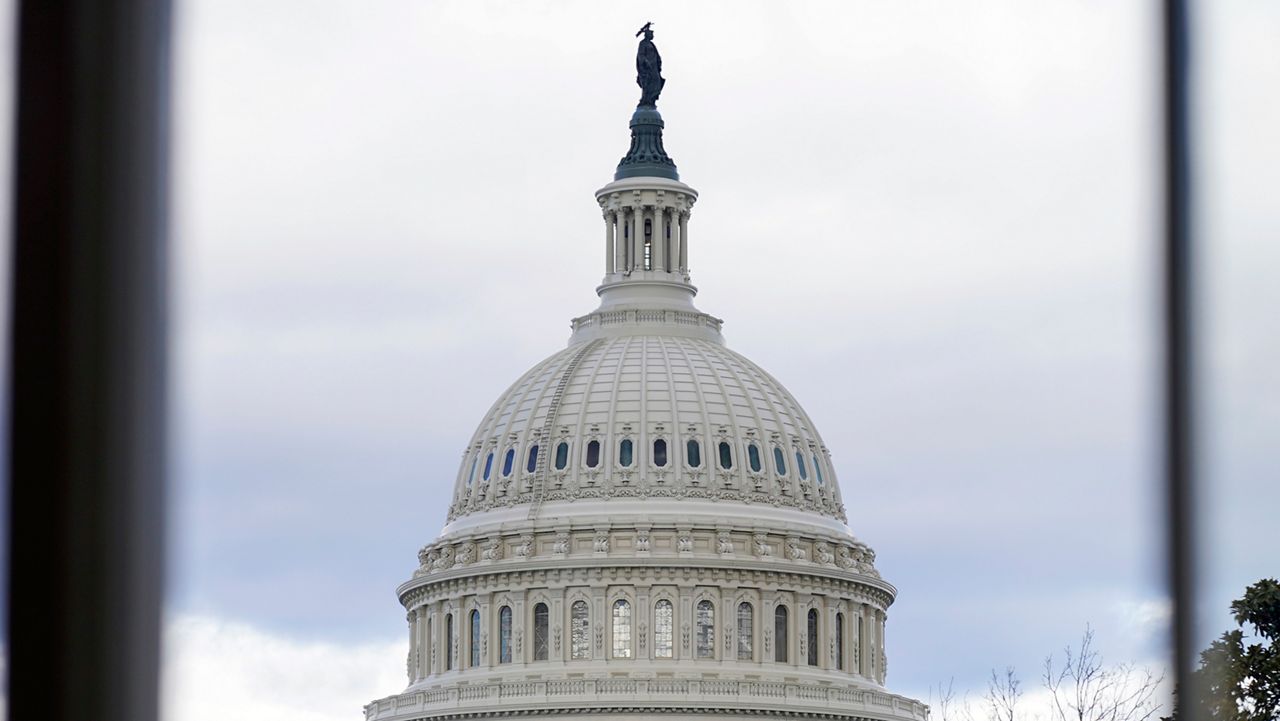 The U.S Capitol photographed through a House Cannon building window on Wednesday, Jan. 10, 2024, in Washington. (AP Photo/Mariam Zuhaib)