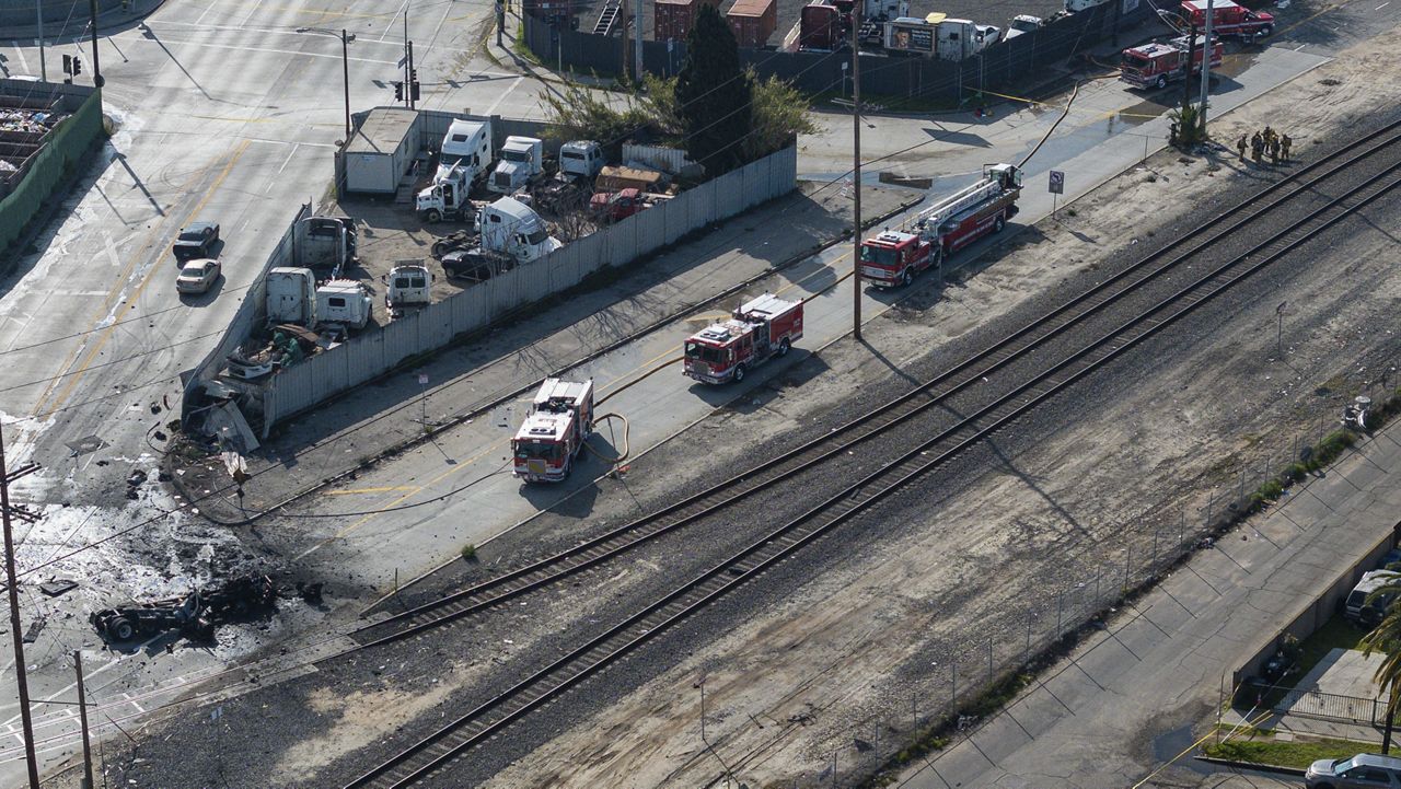 The tractor portion of a big rig, bottom left, is shown in an aerial view on Feb. 15, 2024, in the Wilmington section of Los Angeles. (AP Photo/William Liang)