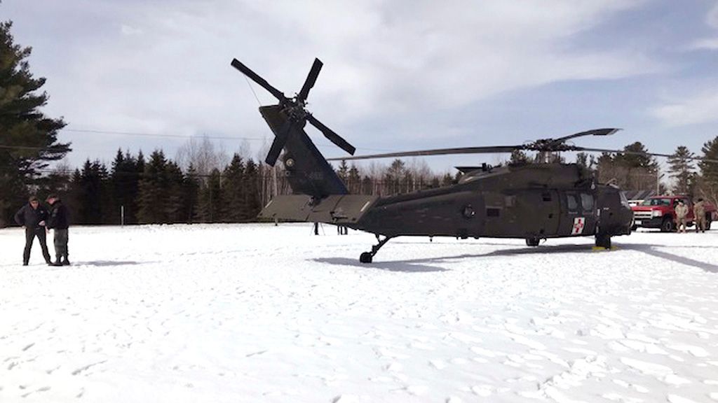 In this U.S. Army photograph by attorney Douglas Desjardins, a damaged Black Hawk helicopter rests on the snow, March 13, 2019, in Worthington, Mass. A Massachusetts man wants the government to pay nearly $10 million after being badly injured in a crash with a Black Hawk helicopter. The lawsuit filed by Jeffrey Smith against the government follows a 2019 crash in which Smith's snowmobile collided with the helicopter that was parked on a trail at dusk. (U.S. Army photograph provided by attorney Douglas Desjardins via AP)