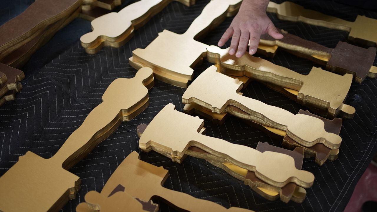 Oscars statue cutouts rest on a table along the red carpet ahead of the 96th Academy Awards Friday, March 8, 2024, in Los Angeles. (AP Photo/John Locher)