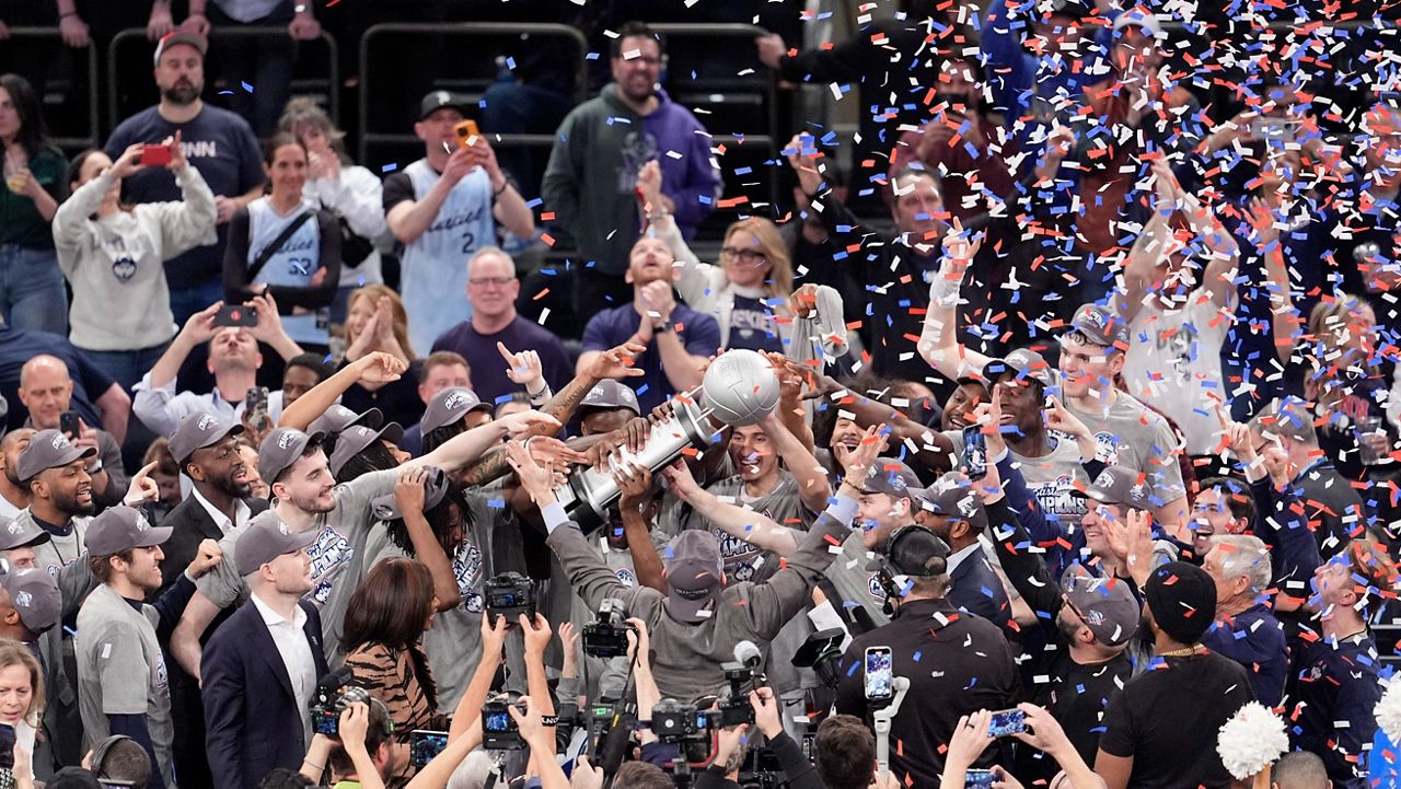 UConn head coach Dan Hurley holds up his arms as his team receives the Big East trophy after defeating Marquette on Saturday, March 16, 2024 in New York.