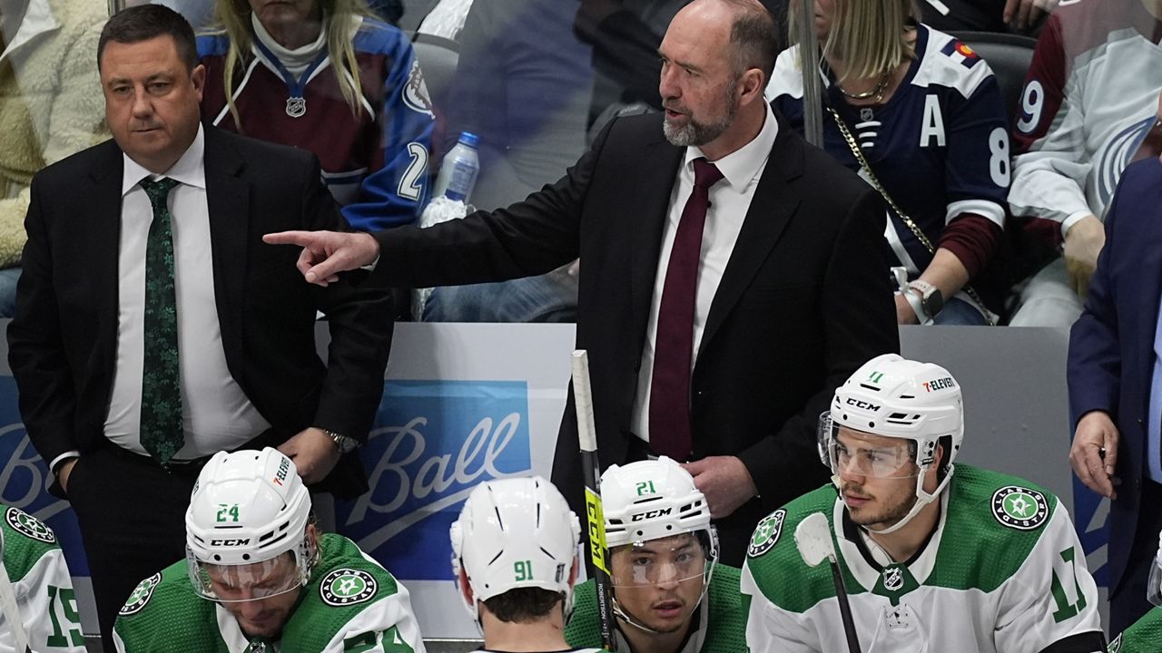 Dallas Stars coach Peter DeBoer, back right, directs players during the third period of Game 3 of the team's NHL hockey Stanley Cup playoff series against the Colorado Avalanche on Saturday, May 11, 2024, in Denver. (AP Photo/David Zalubowski)