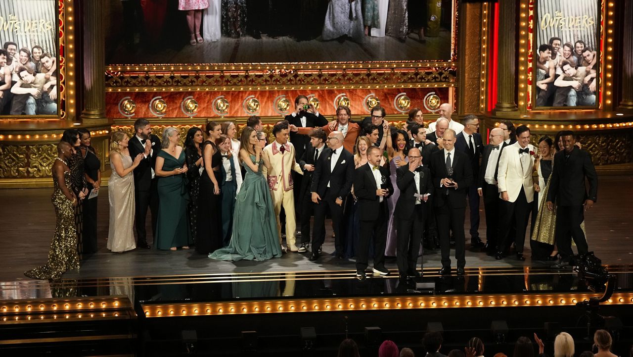 Michael Rego, from center left, Matthew Rego, and Hank Unger and members of the company of "The Outsiders " accept the award for best musical during the 77th Tony Awards on Sunday, June 16, 2024. (Photo by Charles Sykes/Invision/AP)