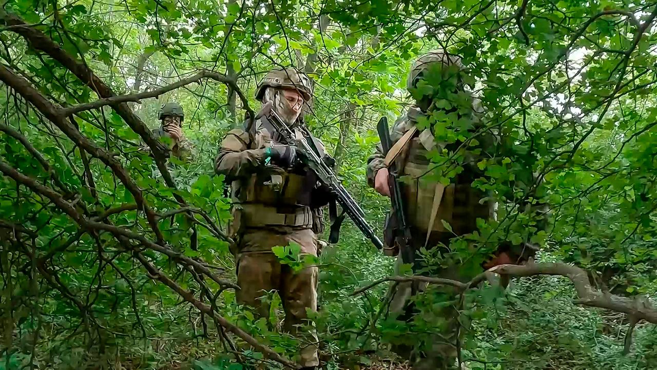 In this photo, taken from video released by the Russian Defense Ministry Press Service on Wednesday, June 12, 2024, Russian soldiers walk through a forest in an undisclosed location in Ukraine. Russia has taken advantage of its edge in firepower amid delays in U.S. aid to scale up attacks in several areas along the 600-mile front. (Russian Defense Ministry Press Service via AP, File)