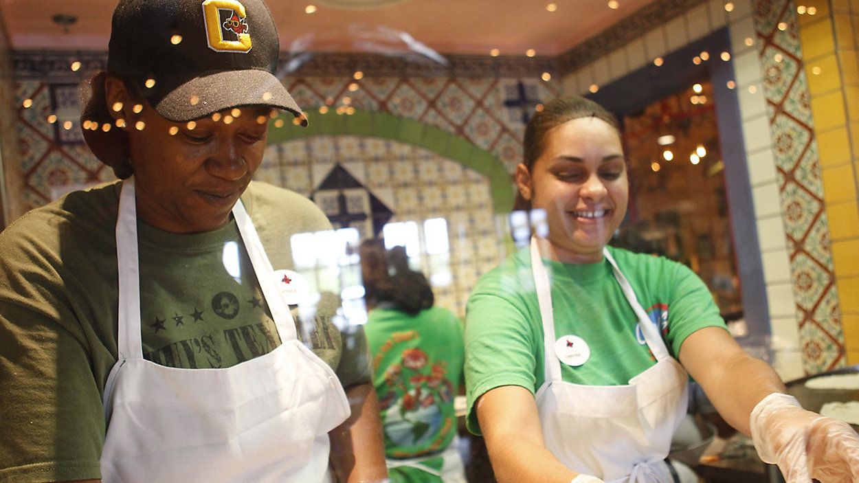 Latrice Walker and Christina Rivera make fresh tortillas on opening day at Chuy's in Jacksonville, N.C., May 13, 2014. On Wednesday, July 17, 2024, Darden Restaurants announced it's buying Chuy's restaurant chain. (AP Photo/The Daily News, Maria Sestito)