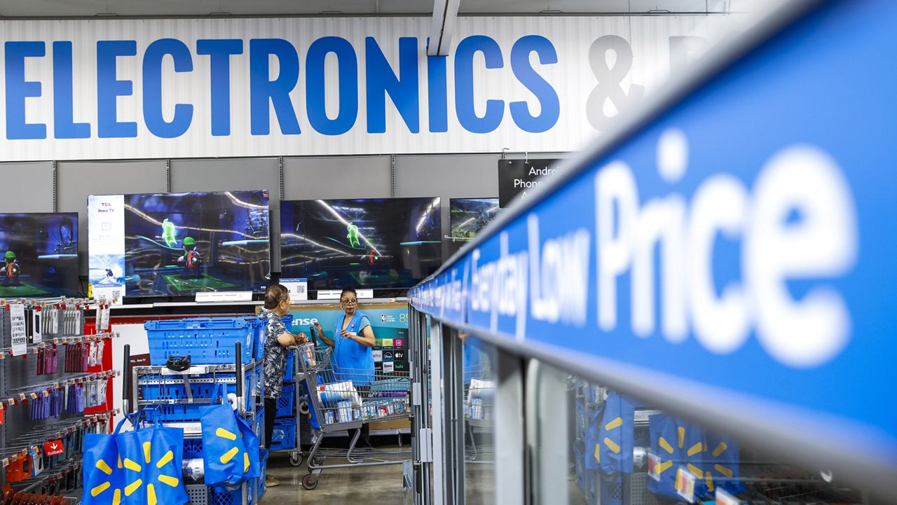 People walk around a Walmart Superstore in Secaucus, New Jersey, on July 11, 2024. (AP Photo/Eduardo Munoz Alvarez, File)