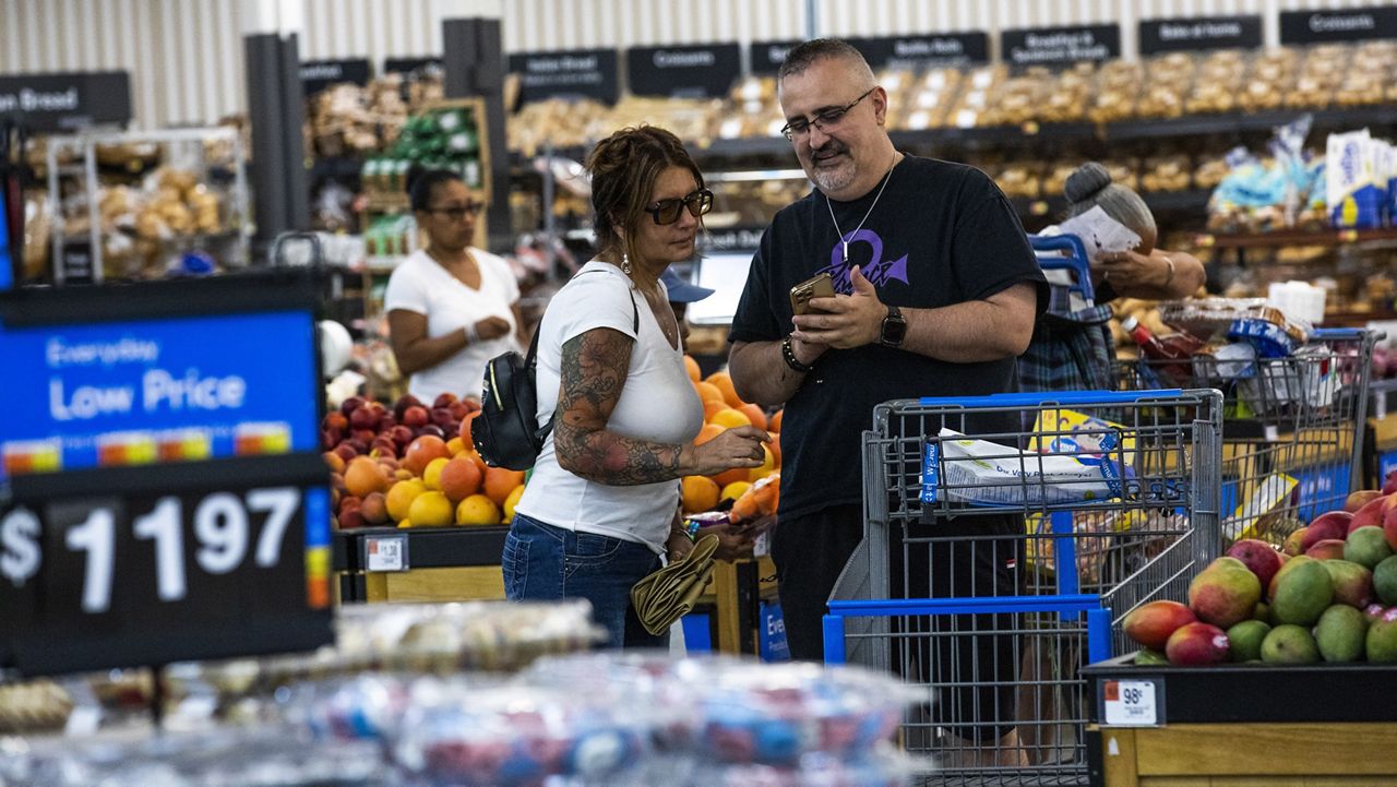 Shoppers pause in the produce section at a Walmart Superstore in Secaucus, New Jersey, July 11, 2024. (AP Photo/Eduardo Munoz Alvarez, File)