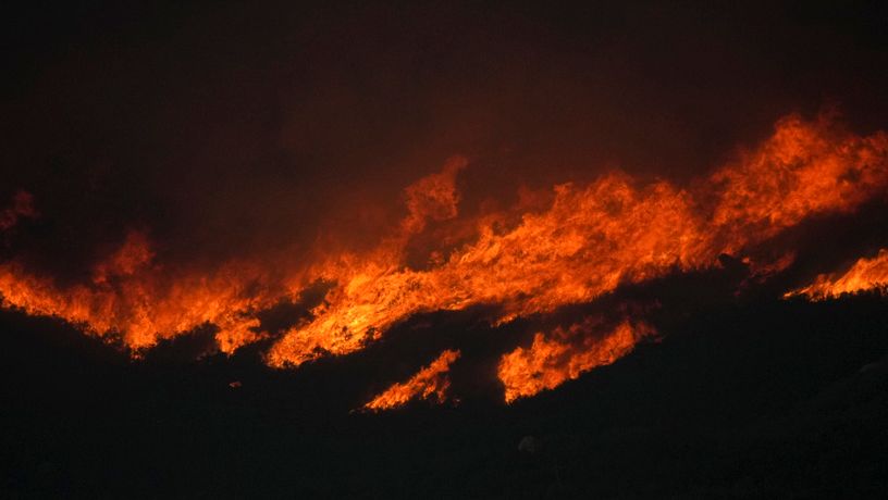 The Airport Fire burns on a mountain top Tuesday, Sept. 10, 2024, in El Cariso, an unincorporated community in Riverside County, Calif. (AP Photo/Eric Thayer)