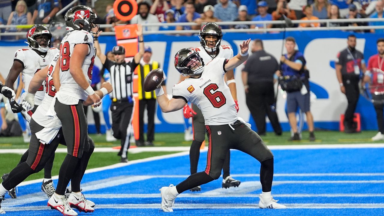 Tampa Bay Buccaneers quarterback Baker Mayfield throws the ball into the stands after his 11-yard rushing touchdown during the second half of an NFL football game against the Detroit Lions, Sunday, Sept. 15, 2024, in Detroit. (AP Photo/Paul Sancya)