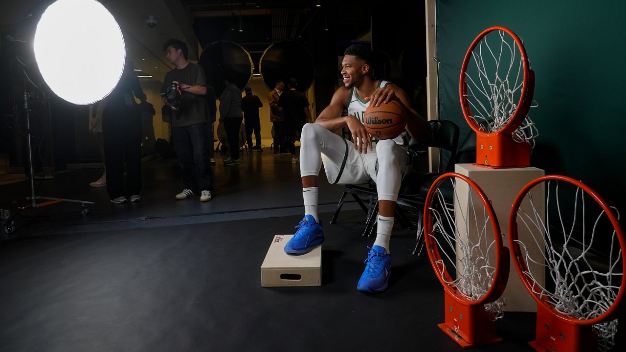 Milwaukeee Bucks' Giannis Antetokounmpo poses for photos during the NBA basketball team's media day Monday, Sept. 30, 2024, in Milwaukee. (AP Photo/Morry Gash)