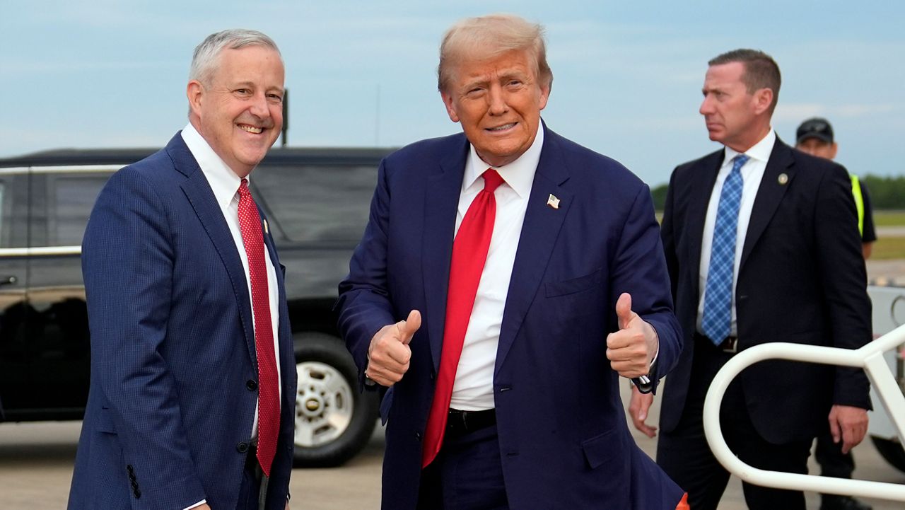 President Donald Trump, then the Republican presidential nominee, stands with Republican National Committee Chair Michael Whatley as he arrives at Fayetteville Regional Airport to attend a town hall, Friday, Oct. 4, 2024, in Fayetteville, N.C. (AP Photo/Evan Vucci, File)