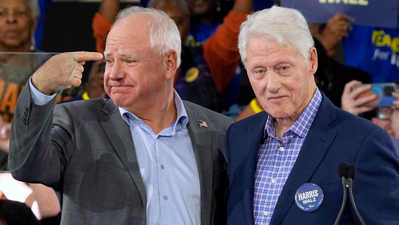 Democratic vice presidential nominee Minnesota Gov. Tim Walz appears with former President Bill Clinton at a campaign rally in Durham, N.C., Thursday, Oct. 17, 2024. (AP Photo/Steve Helber)