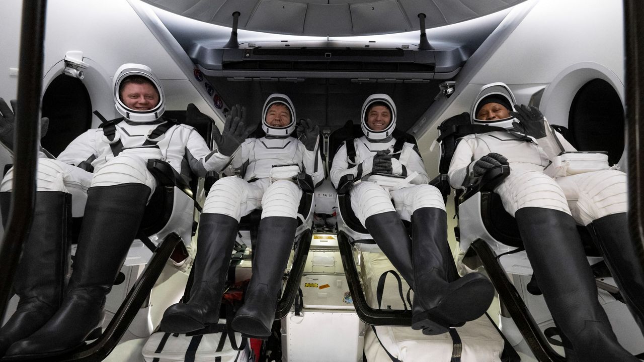 This photo provided by NASA shows Roscosmos cosmonaut Alexander Grebenkin, left, NASA astronauts Michael Barratt, second from left, Matthew Dominick, second from right, and Jeanette Epps, right, inside the SpaceX Dragon Endeavour spacecraft onboard the SpaceX recovery ship MEGAN shortly after having landed in the Gulf of Mexico off the coast of Pensacola, Florida, Friday, Oct. 25, 2024. (NASA/Joel Kowsky via AP)