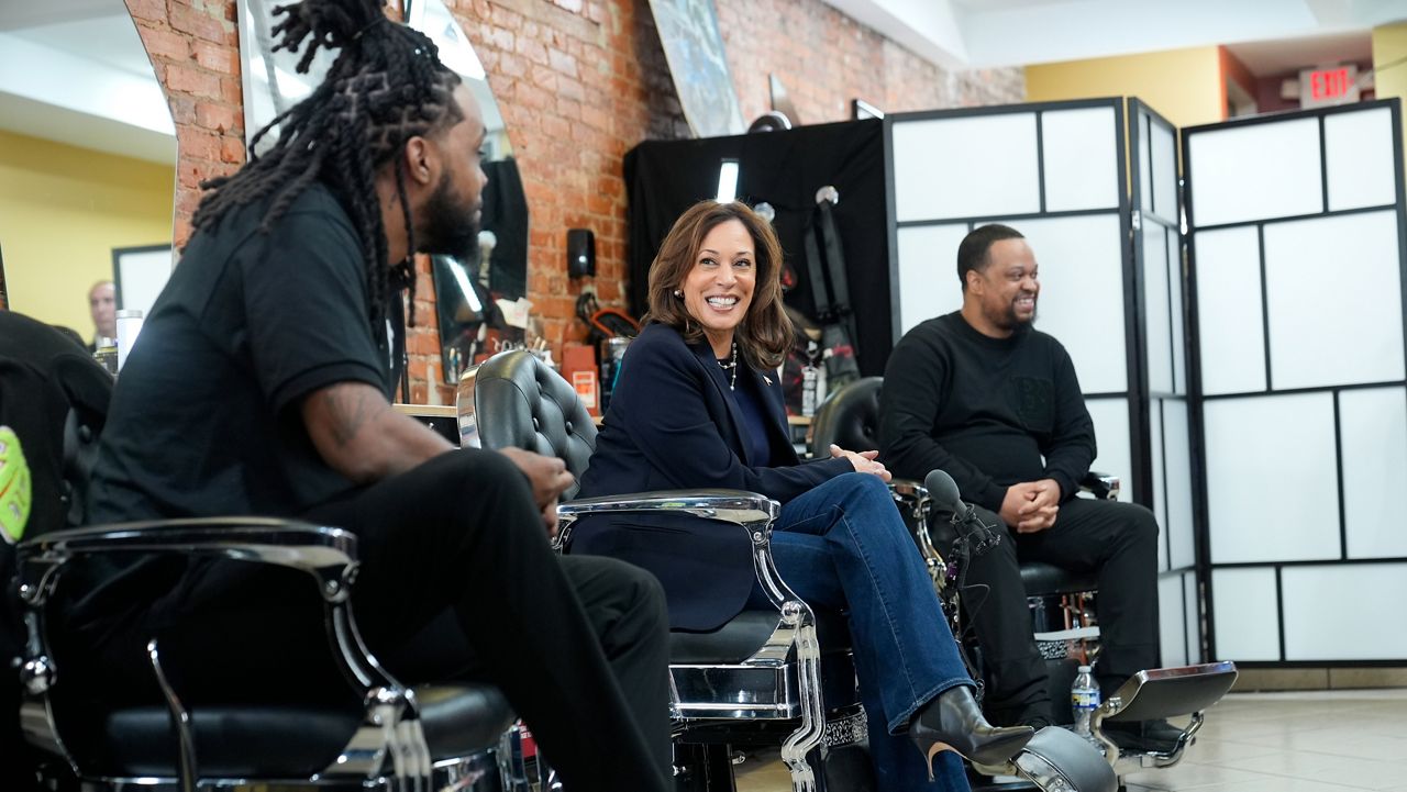 Democratic presidential nominee Vice President Kamala Harris, center, sits in conversation with Black men at Philly Cuts barbershop during a campaign stop, Sunday, Oct. 27, 2024, in Philadelphia. (AP Photo/Susan Walsh)