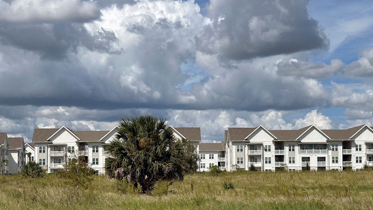 The newly constructed The Brightly Apartments rises from what was formally a citrus grove near Haines City, Florida, on Saturday, Oct. 5, 2024. (AP Photo/Mike Schneider)