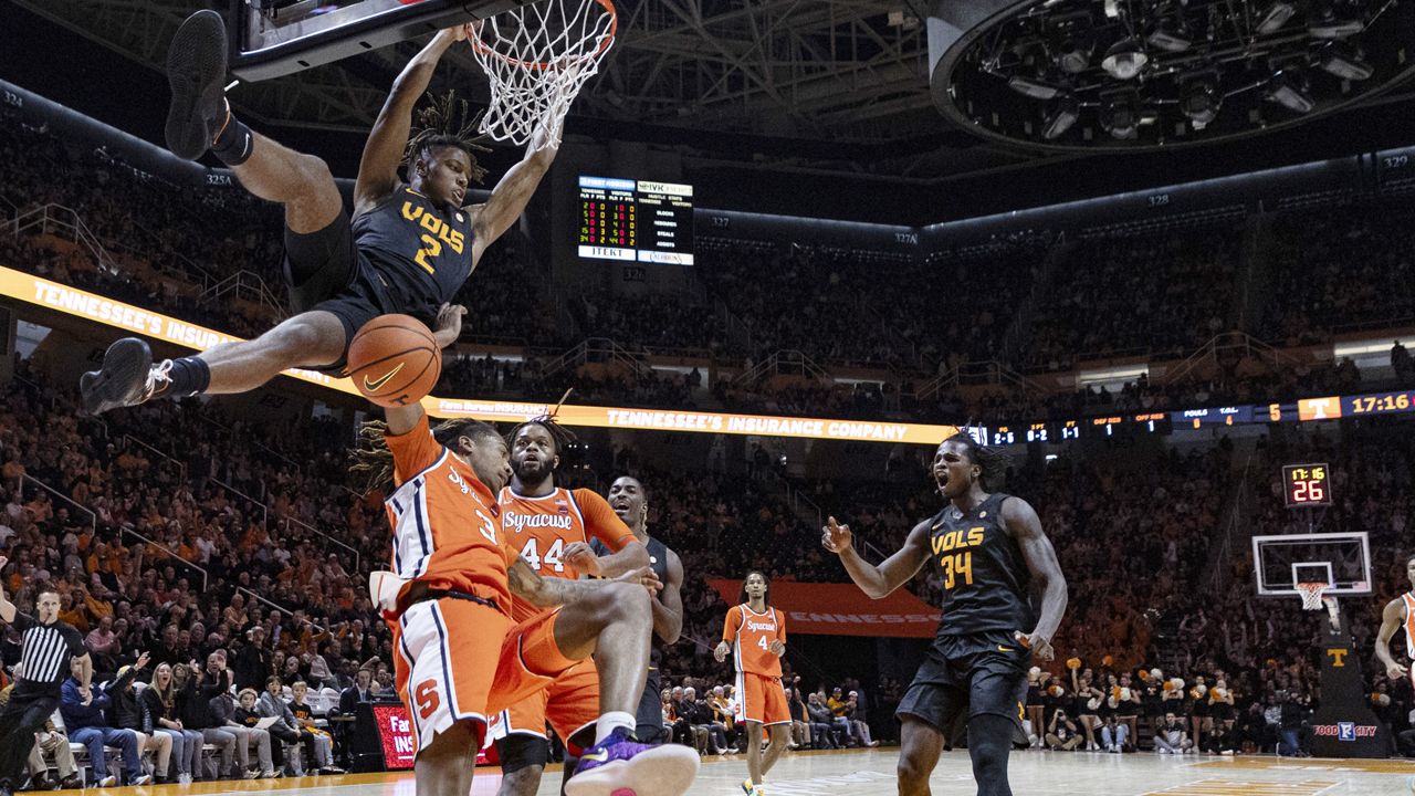 Tennessee guard Chaz Lanier (2) dunks over Syracuse guard Lucas Taylor (3) during the first half of an NCAA college basketball game Tuesday, Dec. 3, 2024, in Knoxville, Tenn. (AP Photo/Wade Payne)