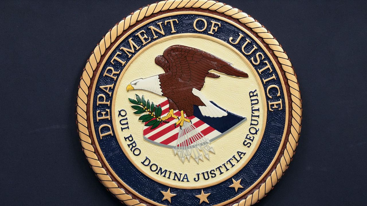 The Department of Justice seal is seen during a news conference Thursday, Dec. 5, 2024, in Memphis, Tenn. (AP Photo/George Walker IV)