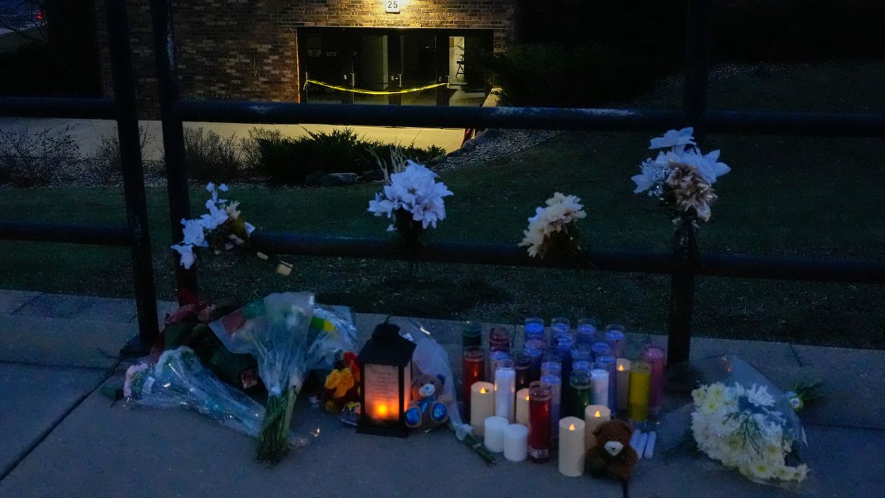 Flowers and candles are placed outside the Abundant Life Christian School Tuesday