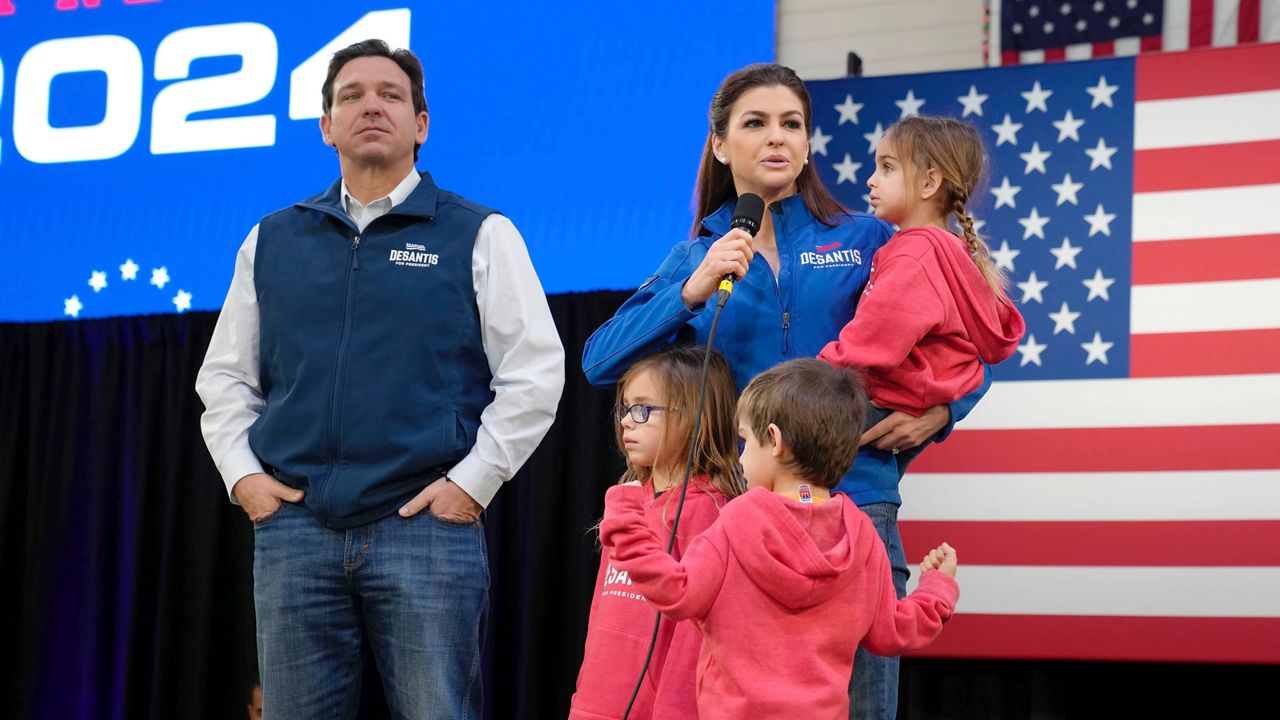 FILE - Republican presidential candidate Florida Gov. Ron DeSantis, left, looks on as his wife Casey DeSantis, carrying daughter Mamie, speaks during a campaign event at The Hangout on Saturday, Jan. 20, 2024, in Myrtle Beach, S.C. Standing in foreground are DeSantis' children Madison, left, and Mason. (AP Photo/Meg Kinnard, File)