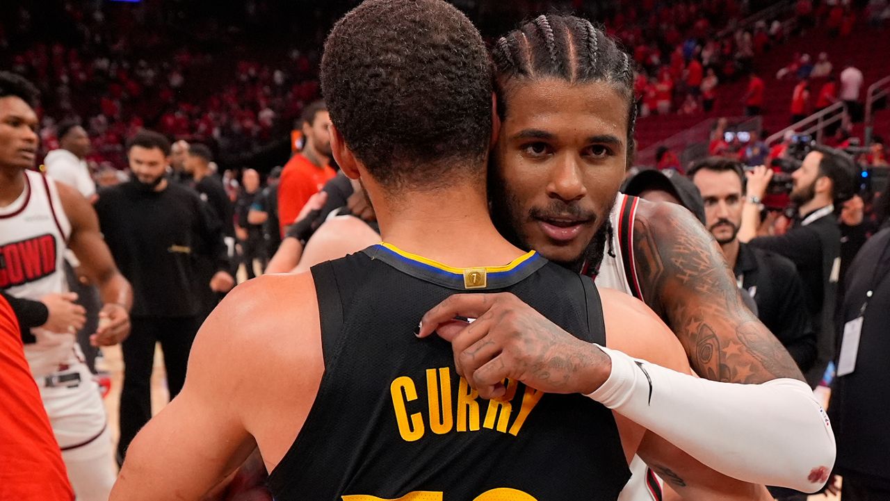 Golden State Warriors' Stephen Curry (30) and Houston Rockets' Jalen Green hug after Game 7 of an NBA basketball first-round playoff series Sunday, May 4, 2025, in Houston. (AP Photo/Ashley Landis)