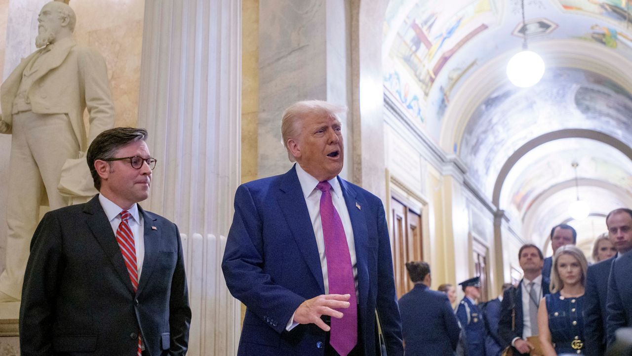 President Donald Trump, right, is joined by Speaker of the House Mike Johnson, R-La., as he arrives for a meeting with the House Republican Conference at the Capitol, Tuesday, May 20, 2025, in Washington. (AP Photo/Rod Lamkey, Jr.)