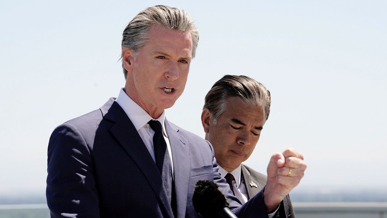 Calif. Gov. Gavin Newsom stands atop the Cal. EPA building. (AP Photo/Rich Pedroncelli)