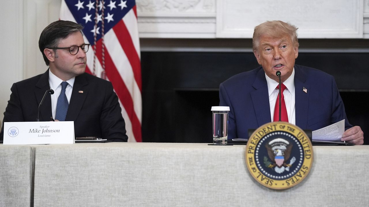 President Donald Trump speaks as House Speaker Mike Johnson, R-La., listens during an 