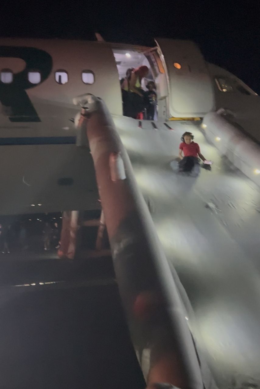 This image provided by Jack Estenssoro, passengers evacuate a airplane after a person was struck and killed by a Frontier Airlines plane during takeoff, at Denver International Airport, Friday, May 8, 2026 in Denver.  (Jack Estenssoro via AP)