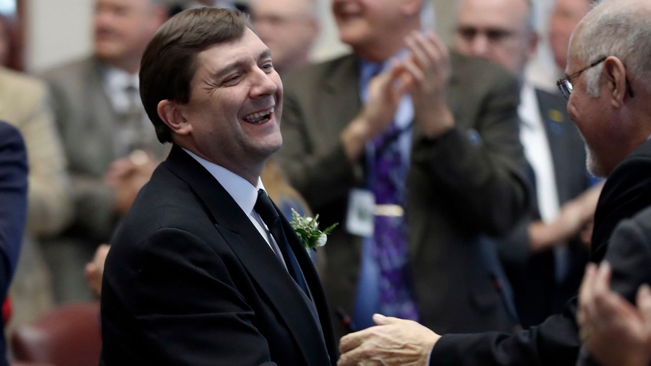FILE - Senate President Troy Jackson, D-Allagash, is greeted by lawmakers as he arrives for joint session in the House Chamber, Wednesday, Dec., 5, 2018, at the State House in Augusta, Maine. (AP Photo/Robert F. Bukaty,File)