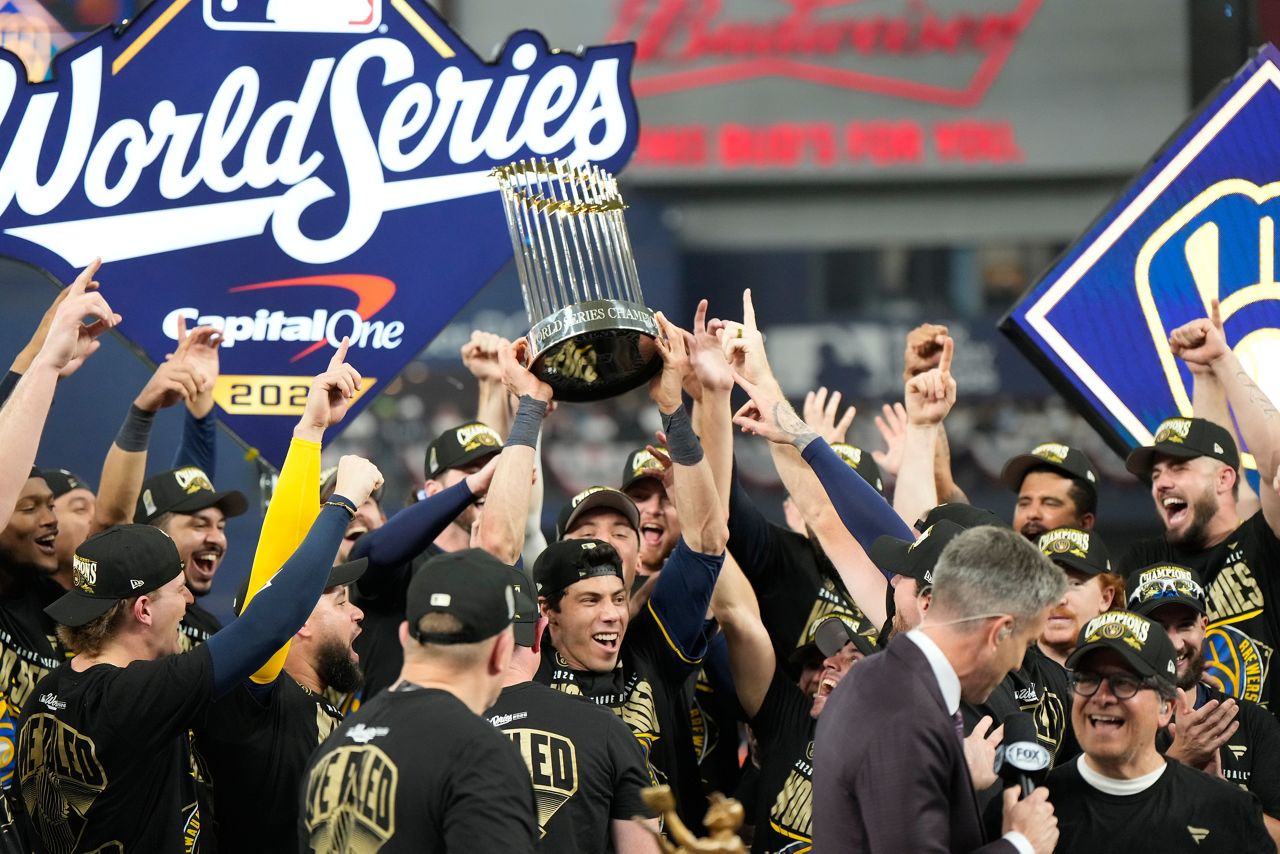 Jackson Chourio poses with the World Series trophy
