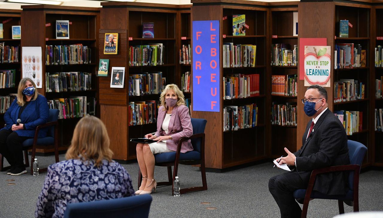 First lady Jill Biden and Education Secretary Miguel Cardona listen to parents as she tours Fort LeBoeuf Middle School in Waterford, Pa., Wednesday, March 3, 2021. (Mandel Ngan/Pool via AP)