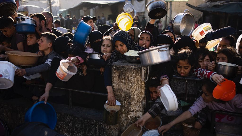 Palestinians line up for a free meal in Rafah, Gaza Strip, on Tuesday, March 12, 2024. (AP Photo/Fatima Shbair)