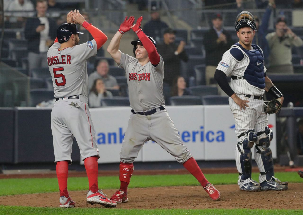 Brock Holt of the Boston Red Sox reacts after hitting an RBI