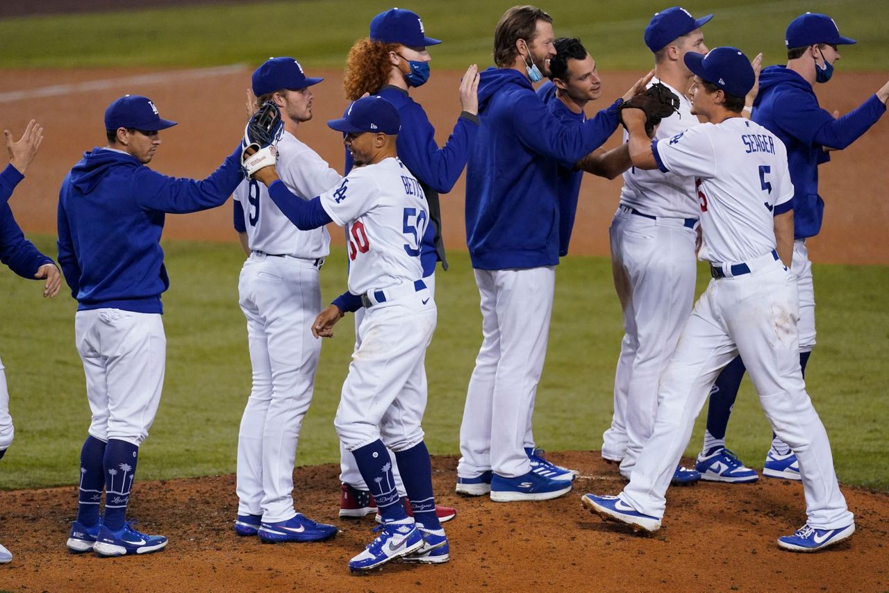 Dodgers clinch NL's top seed, West title with win over A's