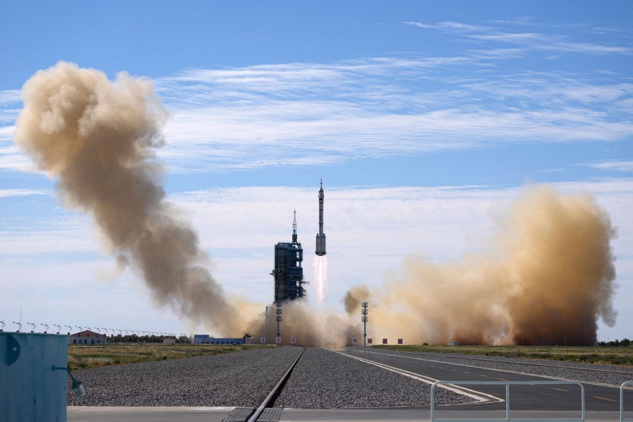 China launches first three-man crew to new space station