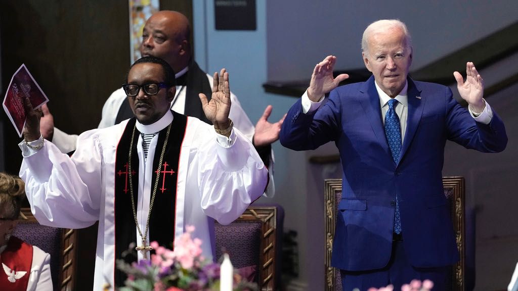 President Joe Biden, right, and pastor Dr. J. Louis Felton pray at a church service at Mt. Airy Church of God in Christ, Sunday, July 7, 2024, in Philadelphia. (AP Photo/Manuel Balce Ceneta)