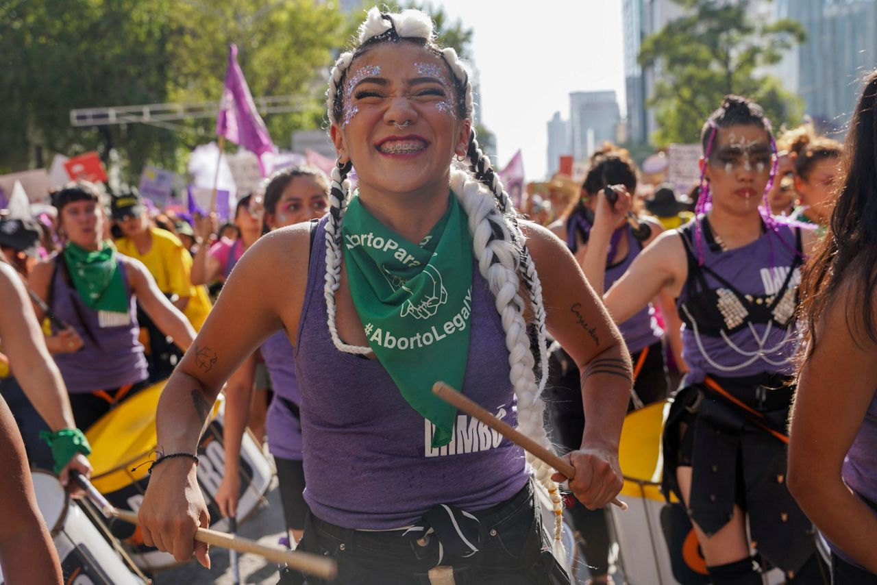 Facing historic shifts, Latin American women bathe streets in purple on  International Women's Day